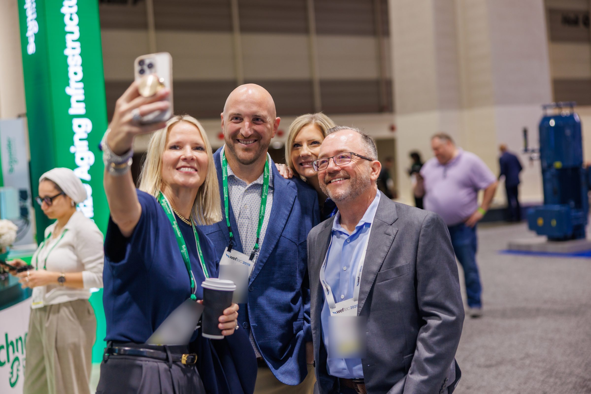 Schneider Electric team taking a selfie at WEFTEC 2026