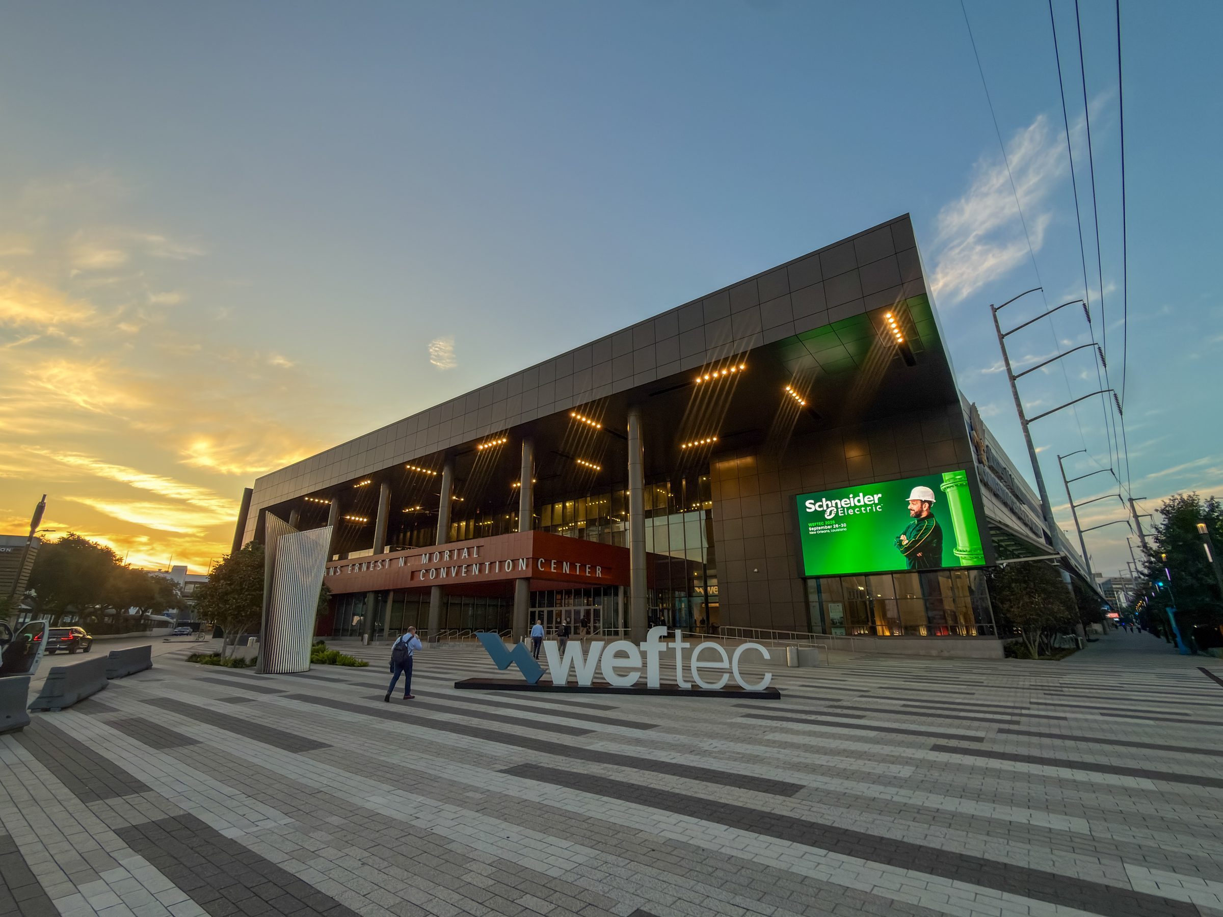 WEFTEC 2026 convention center at sunset with Schneider Electric on the big screen